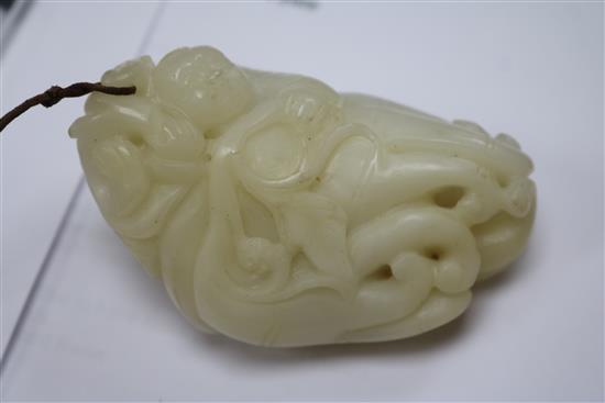 A Chinese white jade carving of a boy clambering on a finger citron, 7.7cm